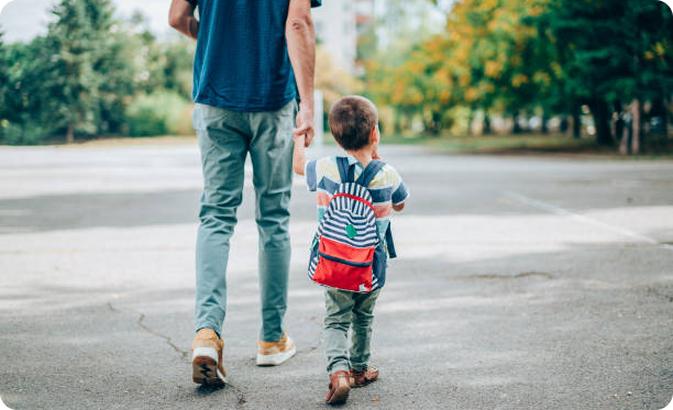 A child and parent on their way to the nursery